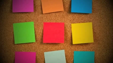 Pieces of note paper on a cork bulletin board Stock Footage 21302228