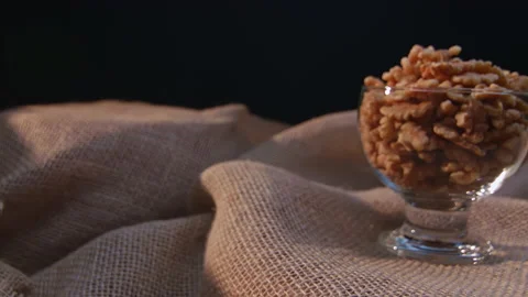 Pieces of nuts in a container Видео 131466017