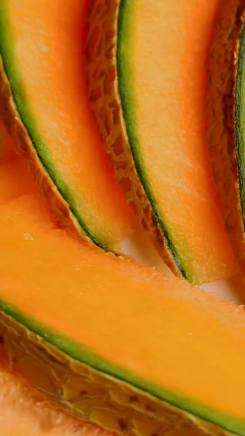 Pieces of orange melon with a peel, rotation in circle. Cantaloupe melon Stock Footage 283727080