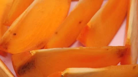 Pieces of persimmon, rotation in circle. orange fresh persimmon (kaki) Stock Footage 255588096