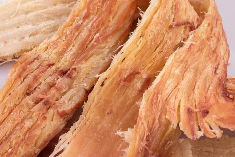 Pieces of peruvian squid close up background. snack for beer. Stock Photos