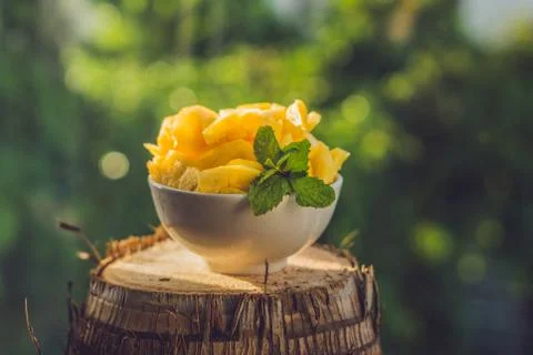 Pieces of pineapple on a background of greenery Stock Photos