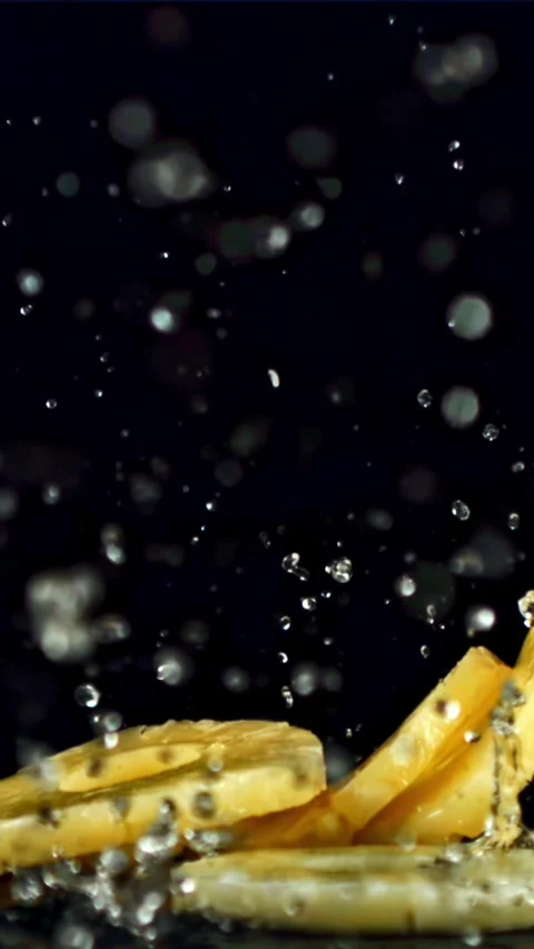 Pieces of pineapple fall on the wet table. Filmed is slow motion 1000 fps Video stock 335293105