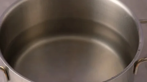 Pieces of potato being put into a pot with boiling water. Making soup. Stock Footage 121853522