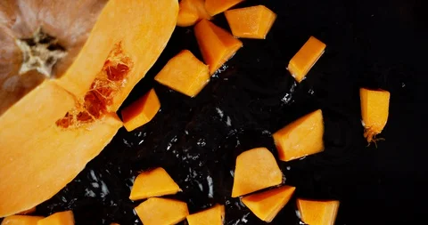 Pieces of pumpkins fall on the water splashes. Stock Footage 130143590