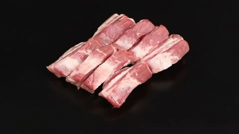 Pieces of raw bacon on a black background. Side view. Stock Footage 221127259