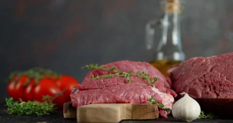 Pieces of raw beef on the table slowly rotate. Stock Footage 139157931