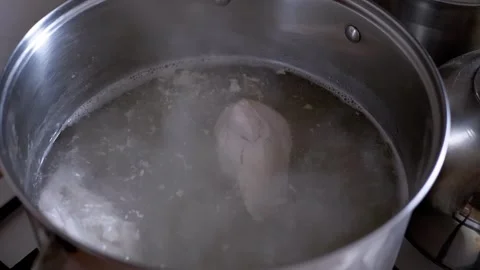 Pieces Of Raw Chicken Breast Boiling In A Large Stainless Steel Pot Stockbeeldmateriaal 332665478
