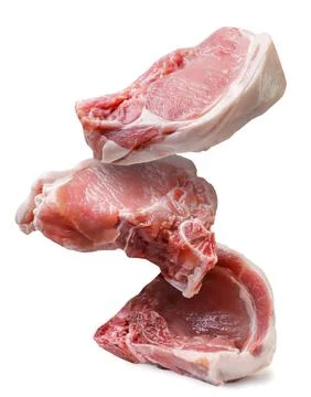 Pieces of raw meat fall close-up on a white background. Stock Photos