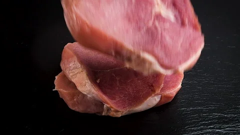 Pieces of raw meat falling on black stone in slow motion 스톡 동영상 231989553
