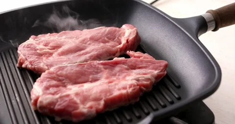 Pieces of raw meat on a grill pan. Stock Footage 250277194