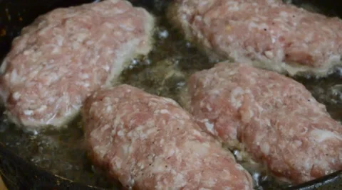 Pieces of Raw Minced Meat Lying on a Frying Pan in Boiling Oil Stock Footage 61519219