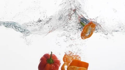 Pieces of red pepper in a water Stock Footage 99724496