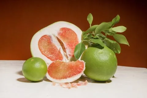 Pieces of red Pomelo fruit on an orange background Stock Photos