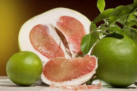 Pieces of red Pomelo fruit on an orange background, Stock Photos