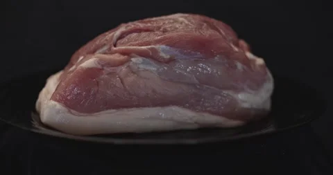 Pieces of rotating meat on a black background, from which blows frosty freshness Stock Footage 130739967