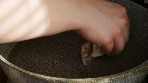 Pieces of salmon spread on the pan.Red fish is fried.Deep skillet for cooking. Stock Footage 129069360