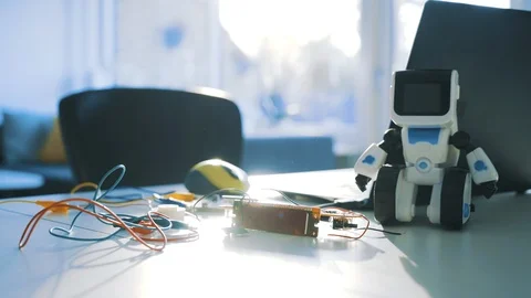 Pieces of a science project lay on a table with electronic parts and wires Stock Footage 102184018