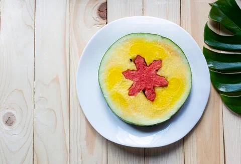 Pieces of star shape red watermelon and yellow melon on a white ceramic plate Stock Photos