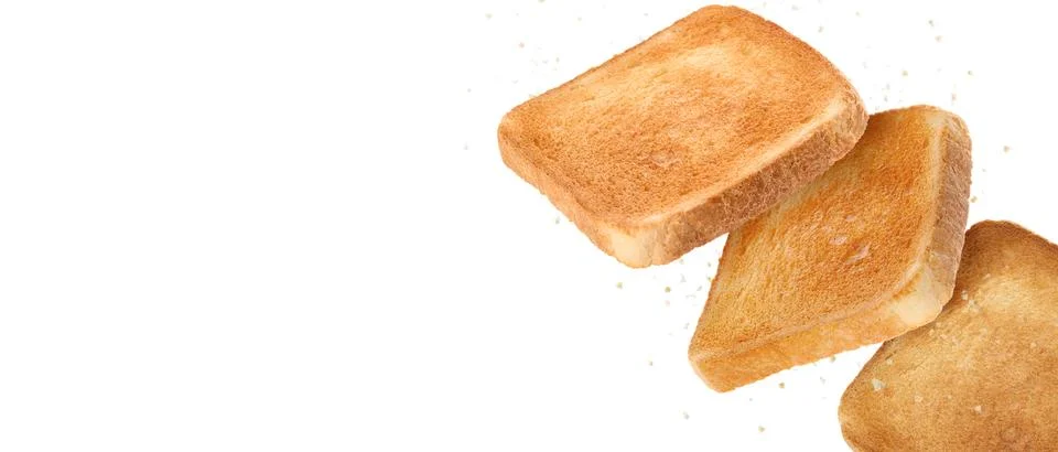 Pieces of toasted bread falling on white background. Banner design with spa.. Stock Photos