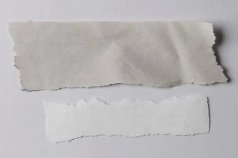 Pieces of torn paper on plain background Stock Photos