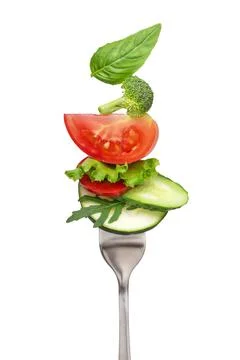Pieces of vegetables on a fork. salad on a fork. Stock Photos