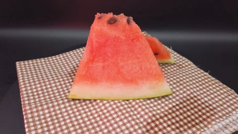 Pieces of watermelon rotate on a dark background Stock-Footage 114239054