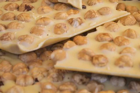 Pieces of white choco with nuts Stock Photos