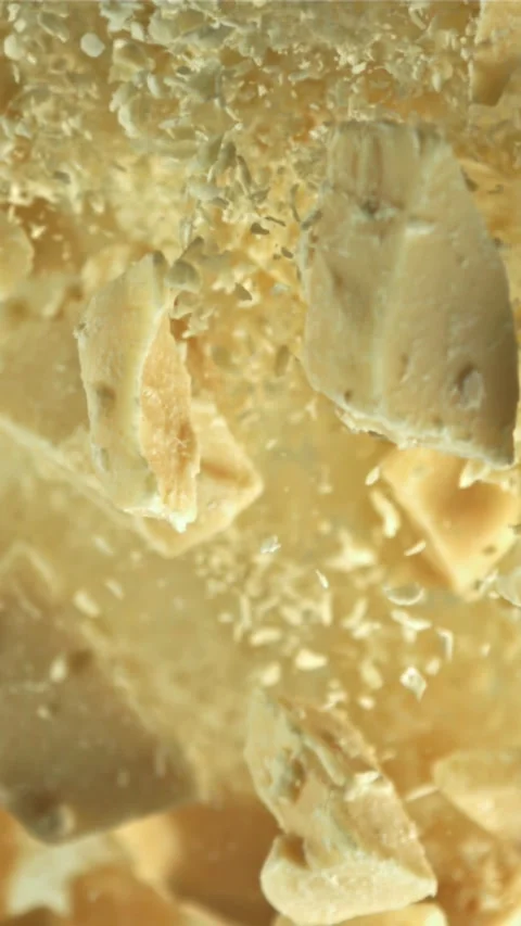 Pieces of white chocolate fly up and fall down. Filmed on a high-speed camera at Stock Footage 335360829