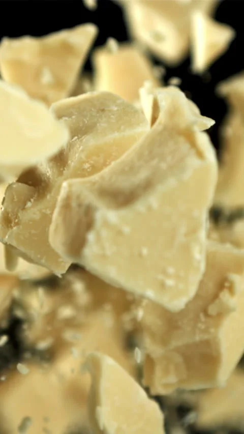 Pieces of white chocolate fly up and fall down. Filmed on a high-speed camera at Stock Footage 335361230