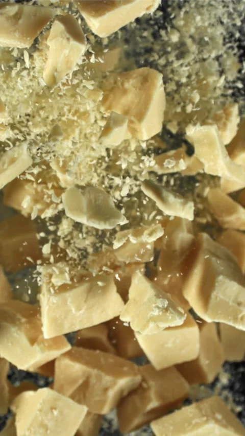 Pieces of white chocolate fly up and fall down. Filmed on a high-speed camera at Stock Footage 335361998