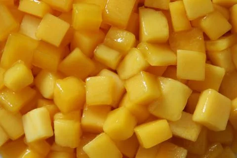 The pieces of yellow mango closeup for background. Stock Photos
