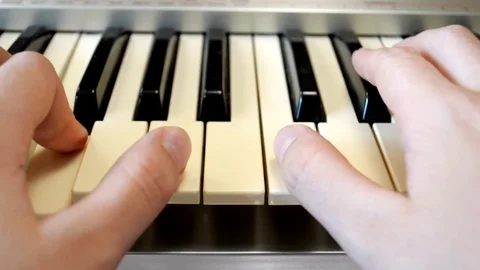 Pienist's hands pushing the keys of a digital keyboard Stock Footage 127699974