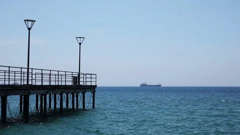 A pier and a distant ship Stock Footage 76968874