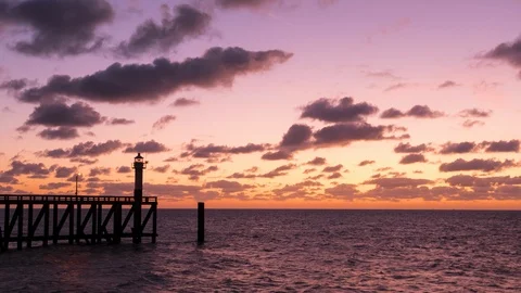 Pier and lighthouse at dusk Stockbeeldmateriaal 116536237