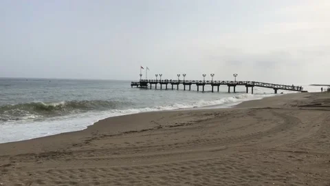 Pier on the beach in Marbella, small waves and sandy beach Stock Footage 132780552