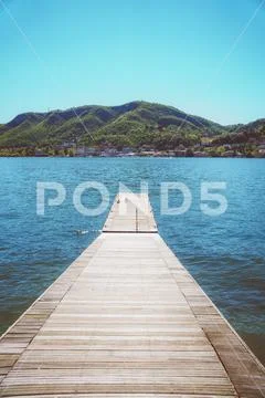Pier on the beautiful summer Como lake in Italy. Stock Photos