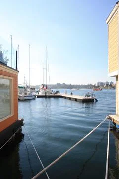 A Pier between the float houses. Stock Photos