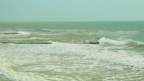The pier is covered with big waves Stockbeeldmateriaal 266445086