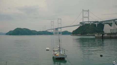 At Pier Ferry floating on water with Long Bridge across between Island Stock Footage 153590428