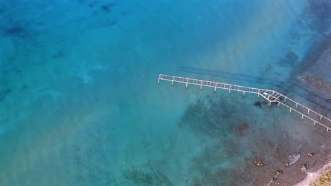 Pier Frame Over Clear Blue Water Drone Shot Video stock 325650913