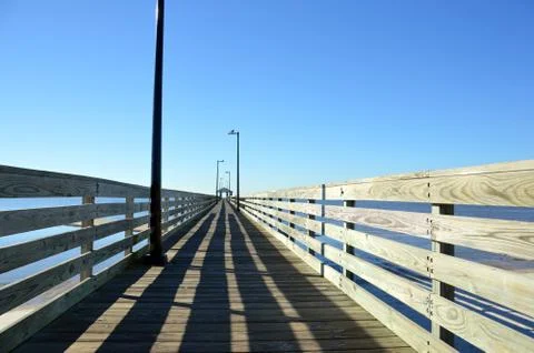 Pier leading into a cloudless sky Foto stock