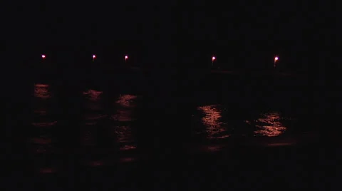 Pier light reflections on night waves Stock Footage 24449629