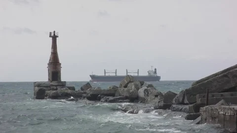 Pier with lighthouse at the background of the ship Stock Footage 80671814