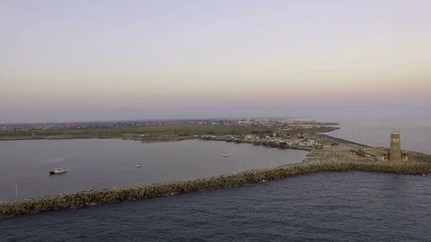 A pier with a lighthouse at sunset. About the boat, sunrise, sea, marina, water Stock Footage 71048456