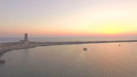 A pier with a lighthouse at sunset. About the sea, marina, water, boat, sunrise Stock Footage 71019875