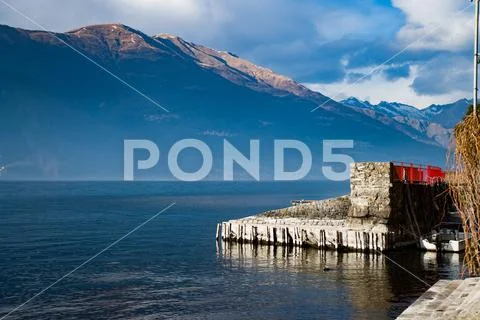 Pier at the Mountain Lake Como Stock Photos