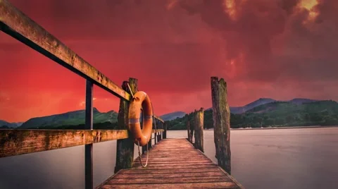 Pier Overlooking Lake With Red Background Clouds in Timelapse Video stock 58206887