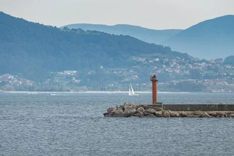 Pier with red lighthouse in Spain Stock Photos