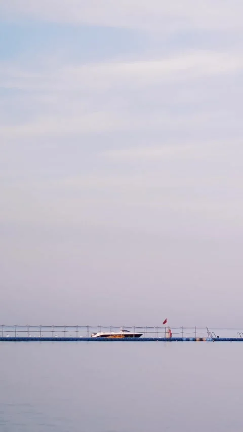 Pier, red sea is calm, windless weather, there are clouds in the sky, you can Stock-Footage 319294829